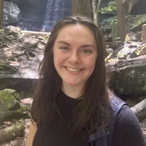 Sophia Eastman ’26 standing in front of a waterfall