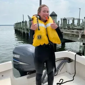 Seychelle Brainard in a wetsuit and life preserver during her internship with NOAA.