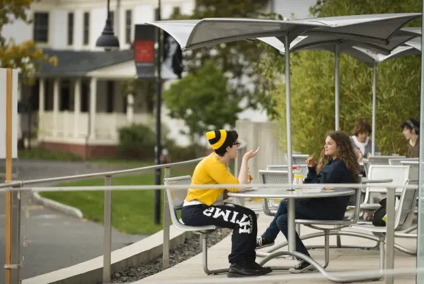 Two students sitting outside of the Campus Center.